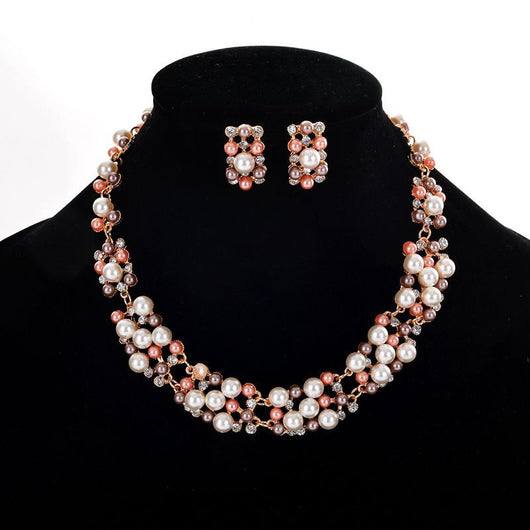 Gold-toned heart-shaped necklace and dangle earrings set with clear rhinestones and faux pearls. - Image 4
