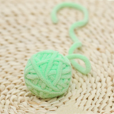 Colorful plush yarn ball cat toy in pink, blue, and white, with a long trailing strand, on a light background. - Image 33