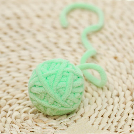 Colorful plush yarn ball cat toy in pink, blue, and white, with a long trailing strand, on a light background. - Image 33