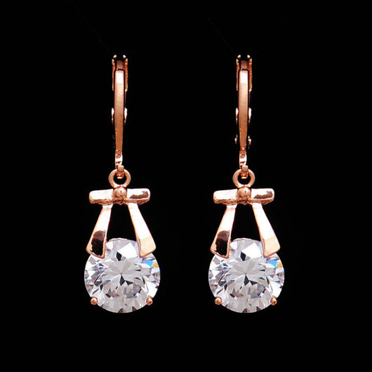 Rose gold-toned jewelry set with a necklace and matching dangle earrings, each featuring a round clear crystal. - Image 2