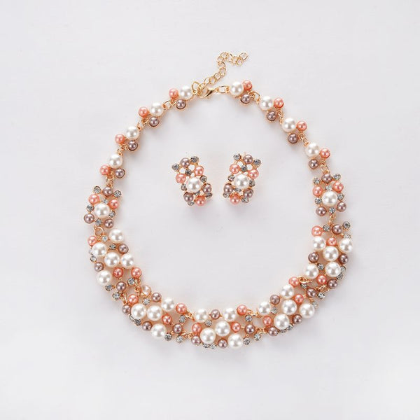 Gold-toned heart-shaped necklace and dangle earrings set with clear rhinestones and faux pearls. - Image 6