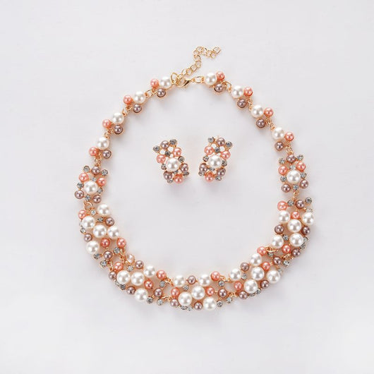 Gold-toned heart-shaped necklace and dangle earrings set with clear rhinestones and faux pearls. - Image 6