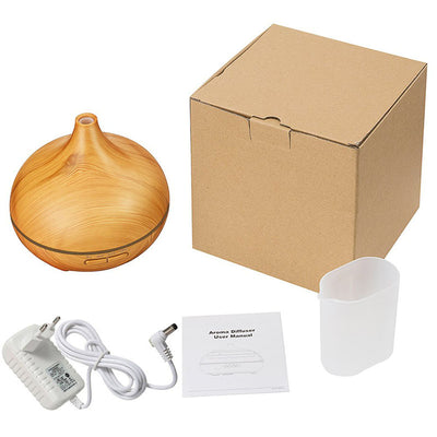 Wood grain ultrasonic aromatherapy diffuser and humidifier with a glowing blue LED light band and control buttons. - Image 4