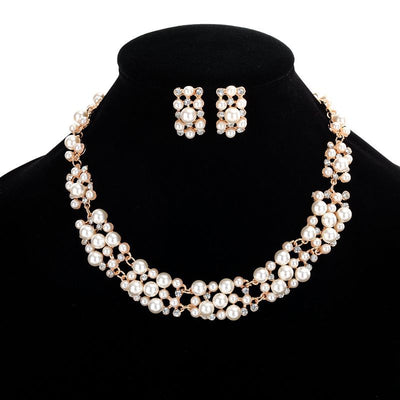 Gold-toned heart-shaped necklace and dangle earrings set with clear rhinestones and faux pearls. - Image 3