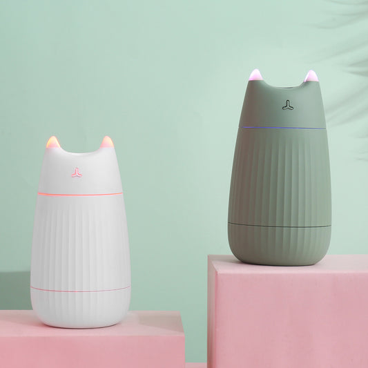 Pink cat-shaped humidifier with pointed ears and a ribbed texture on the lower body, ideal for desktop use.