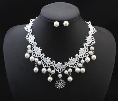 White lace choker necklace with dangling faux pearls and a central rhinestone pendant on a black jewelry bust. - Image 5