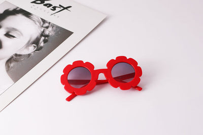 Light blue flower-shaped sunglasses with dark lenses, featuring a playful design and plastic frame. - Image 9