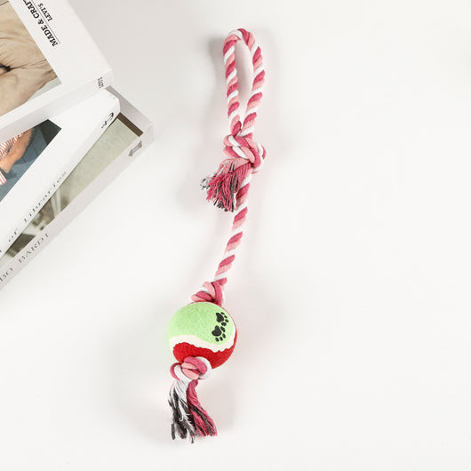 Red, pink, and white braided cotton rope dog toy with a green and red tennis ball featuring black paw prints. - Image 11