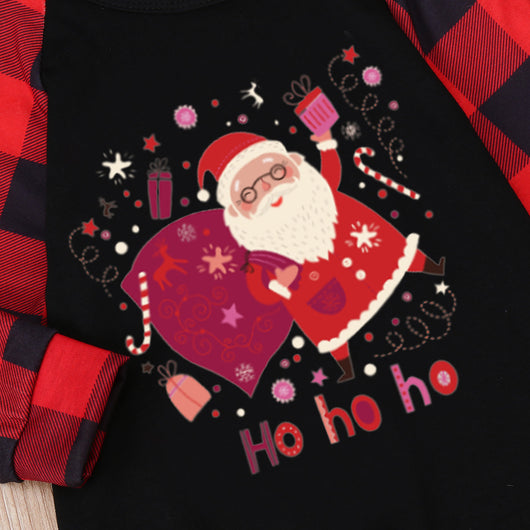Family matching Christmas pajamas with black tops featuring a Santa graphic and red buffalo plaid sleeves and pants. - Image 8