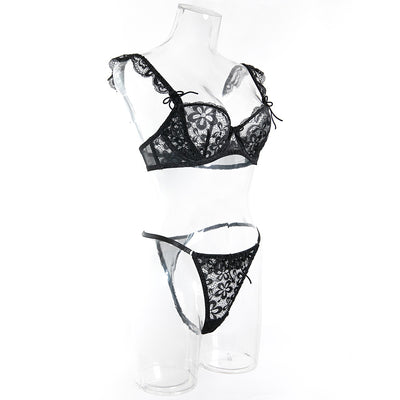 Black sheer lace lingerie set with floral patterns, including an underwire bra and matching thong, on pink satin. - Image 15