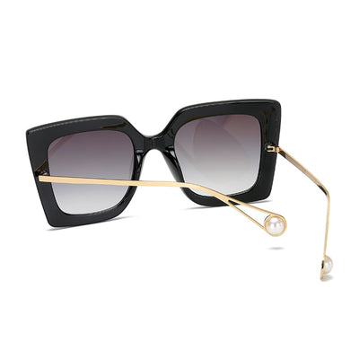 Women's black square frame sunglasses with blue gradient lenses and gold metal temples featuring a pearl accent. - Image 4