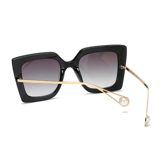 Women's black square frame sunglasses with blue gradient lenses and gold metal temples featuring a pearl accent. - Image 4