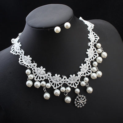 White lace choker necklace with dangling faux pearls and a central rhinestone pendant on a black jewelry bust. - Image 3