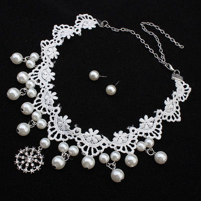 White lace choker necklace with dangling faux pearls and a central rhinestone pendant on a black jewelry bust. - Image 2
