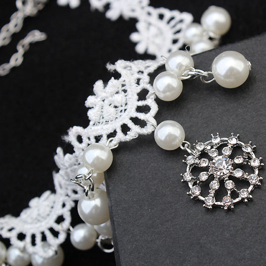 White lace choker necklace with dangling faux pearls and a central rhinestone pendant on a black jewelry bust. - Image 4