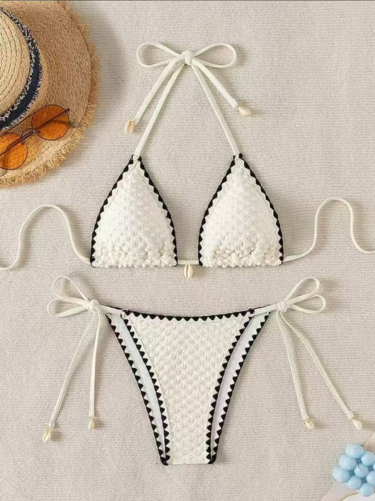 Black textured bikini with white scalloped trim, halter top, and tie-side bottoms featuring small shell details. - Image 8