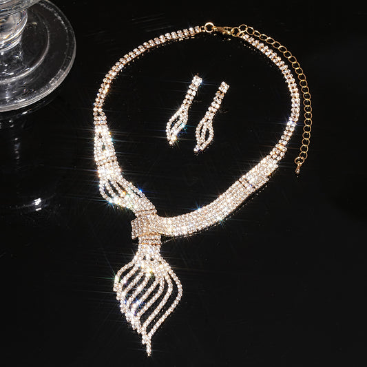 Gold-tone rhinestone necklace and matching dangle earrings set. The necklace features a multi-strand, leaf-like design. - Image 2