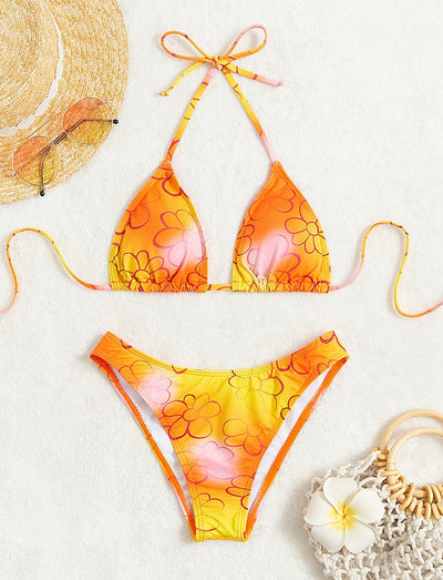 Yellow and orange floral string bikini swimsuit for women, featuring a triangle top and high-cut bottoms by a pool. - Image 9