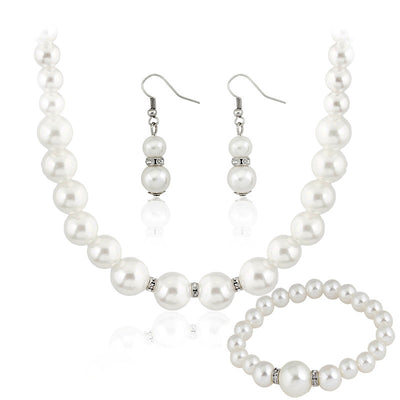 Three-piece white faux pearl jewelry set with rhinestone accents, including a necklace, drop earrings, and a bracelet. - Image 2