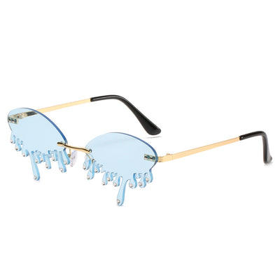 Rimless sunglasses with dark gray dripping liquid-shaped lenses, silver studs, and gold metal frames. - Image 13