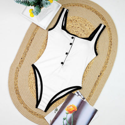 Woman in a white one-piece swimsuit with black trim and decorative buttons, sitting on a boat. - Image 14