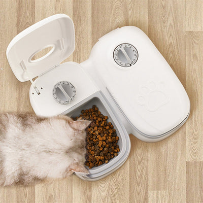 White automatic pet feeder with a pink timer dial and an embossed paw print on the lid. - Image 15