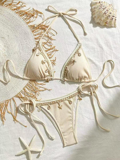 Light pink ribbed halterneck bikini with triangle cups and tie-side bottom, adorned with shell and starfish charms. - Image 7