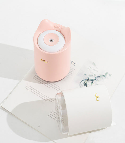 White mini USB humidifier with cat ears and a gold cat nose/mouth emblem, featuring a clear water tank base. - Image 3