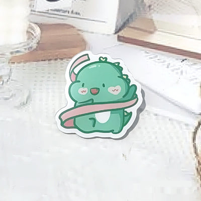 Cute green cartoon dinosaur acrylic badge brooch with a shy expression and small spikes on its back. - Image 24