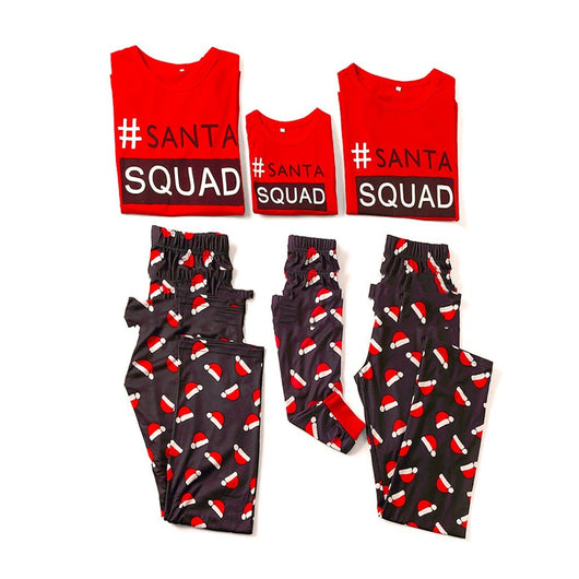 Matching family Christmas pajamas with red long-sleeve tops reading "#SANTA SQUAD" and black pants with a red Santa hat pattern.