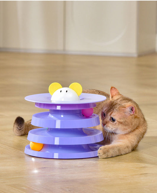 Brown tabby cat sniffing a black and orange multi-level rotating cat plate toy with colorful balls and bunny ears. - Image 14