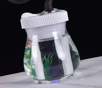 Creative desktop humidifier with artificial red roses, clear base, pink top, and color-changing LED light mist. - Image 15
