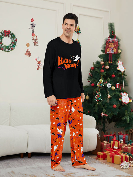 Family of four wearing matching black and orange Halloween long-sleeve pajamas with ghost and bat prints. - Image 10