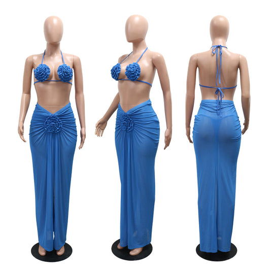 Blue three-piece bikini set with floral appliques on the triangle top, thong bottom, and matching ruched maxi skirt. - Image 15