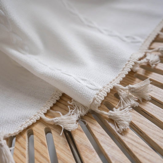 Black polyester curtain with white jacquard multi-line pattern and black tassels, draped over a white chair. - Image 15