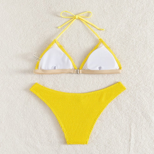 Bright yellow textured two-piece bikini with a triangle top and high-cut bottom, modeled on a person. - Image 9