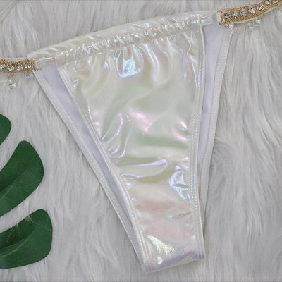 Iridescent purple and pink two-piece bikini with gold-toned crystal embellishments on a white faux fur background. - Image 18