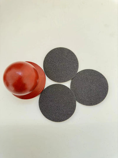 Red wooden dog claw grinding tool with a spherical handle and three circular black abrasive sanding pads. - Image 11