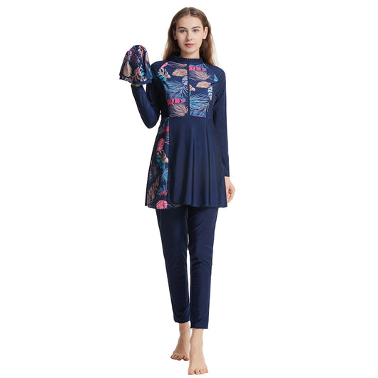 Woman in a navy blue quick-drying conservative swimwear set with a tropical leaf print tunic and matching swim cap. - Image 5