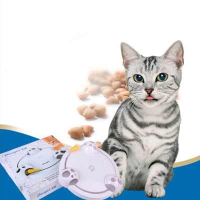 White interactive cat toy with a yellow feather, designed for mouse pouncing, next to a silver tabby cat.