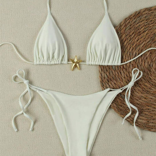 White two-piece bikini with triangle top and tie-side bottom, featuring a gold starfish charm.