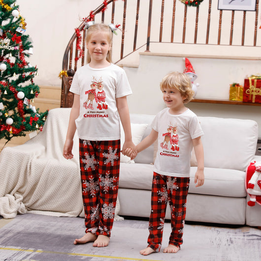 Family of five wearing matching Christmas pajamas with white 'Cousin Crew' tops and red plaid snowflake pants. - Image 11