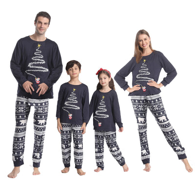 Family of four wearing matching red Christmas pajamas with white Christmas tree tops and polar bear print pants. - Image 2