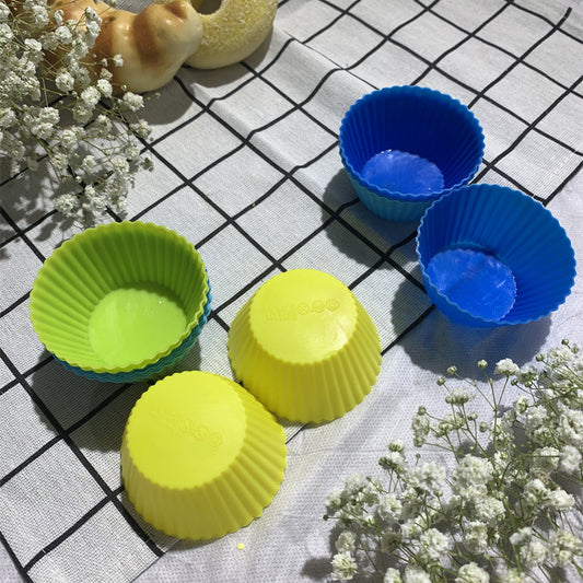Six colorful silicone cupcake liners in red, blue, hot pink, yellow, pink, and lime green on a white background.