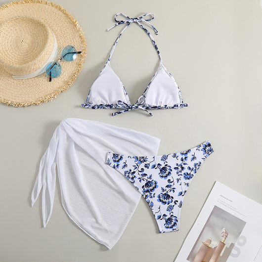 White and yellow floral print three-piece bikini set with a halter triangle top, high-cut bottom, and sheer white sarong. - Image 28