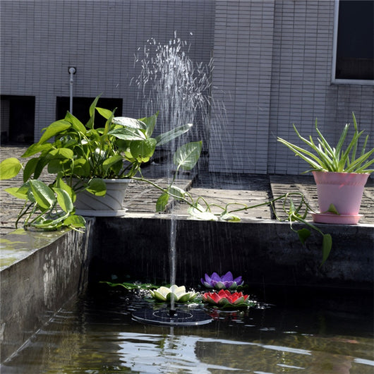 5W solar fountain kit with black solar panel on a ground stake, water pump, coiled hose, and various nozzles. - Image 27