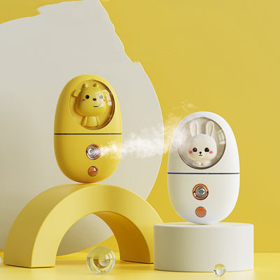 White egg-shaped portable facial humidifier with a pink cartoon rabbit inside a clear dome, gold nozzle and button. - Image 19