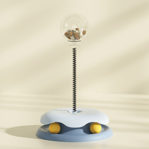 Mint green and dark green cat leakage food toy with a clear spherical treat dispenser on a black spring. - Image 8