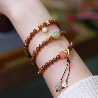 Pulsera de Tres Aros con Perla de Calabaza y Mariposa - Image 7