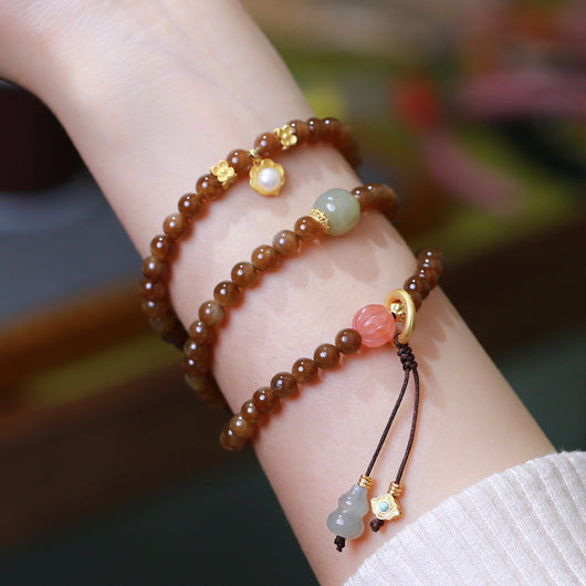 Pulsera de Tres Aros con Perla de Calabaza y Mariposa - Image 7